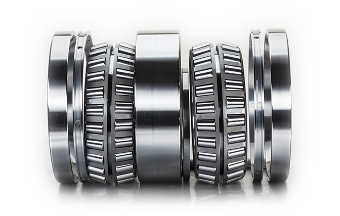 How does the design of Four Row Tapered Roller Bearings contribute to their durability and reliability in heavy-duty applications?